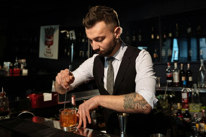 a man at a bar is making a drink