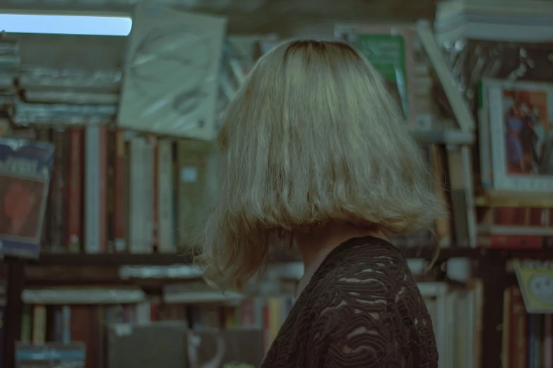 an up - close view of the back of a woman's head at a bookstore