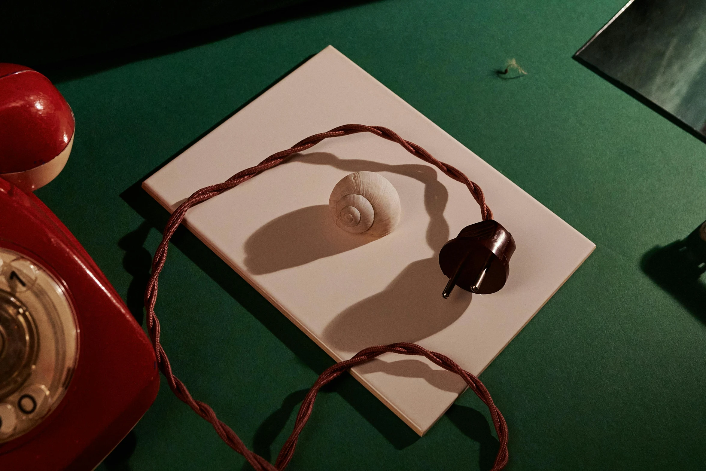 a red telephone next to a card with a heart design on it