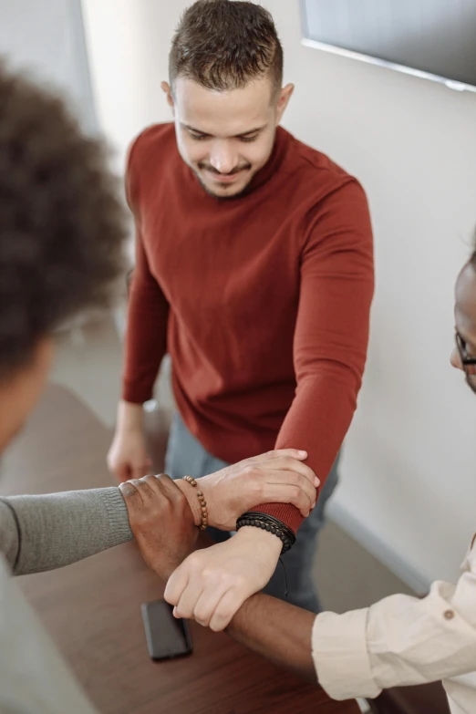 two people are standing and exchanging the same deal