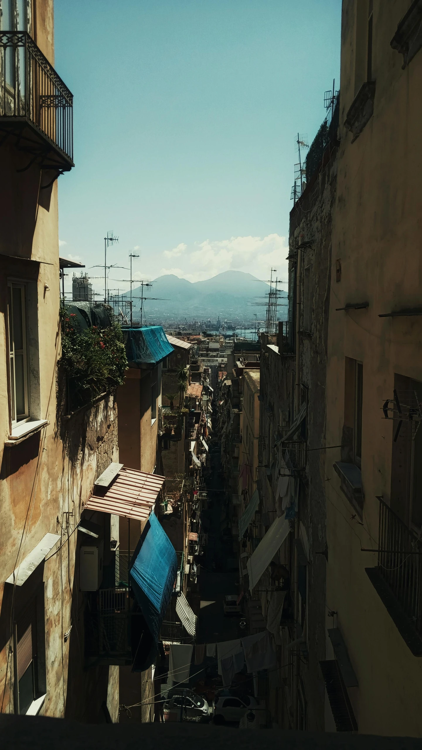 a street and rooftop view of the mountains