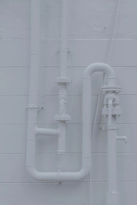 pipes hanging on the wall next to each other