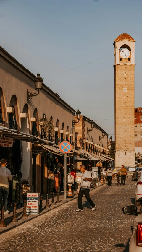 a street scene with a tower clock on a building