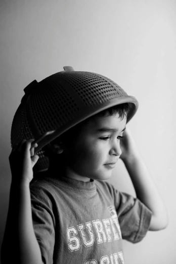 black and white pograph of a boy wearing a hat