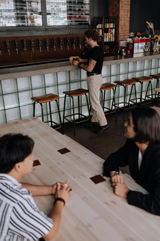 a bar with some people sitting at the bar