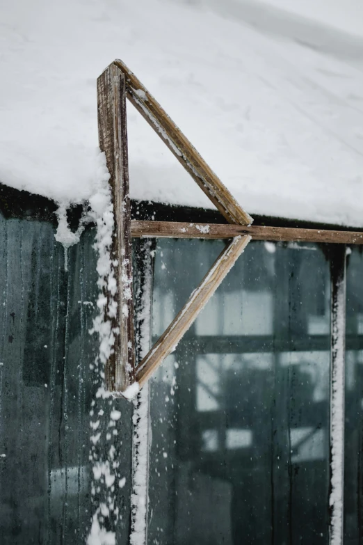 a wooden window frame standing in the snow