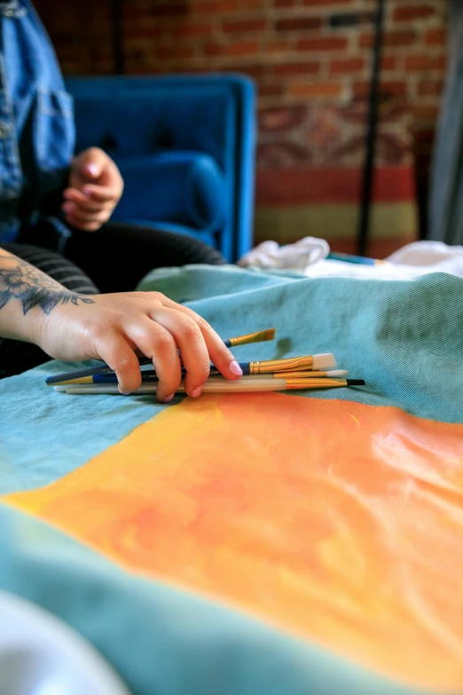 a person using a pair of scissors on a cloth