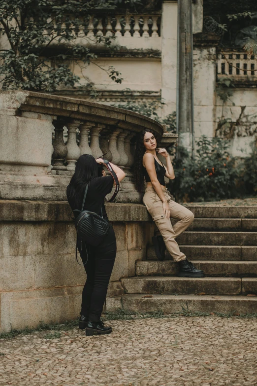 two woman are taking pictures of a building