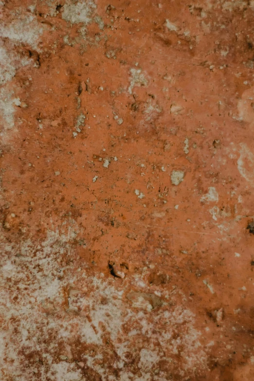 an orange wall with scratches and dirt