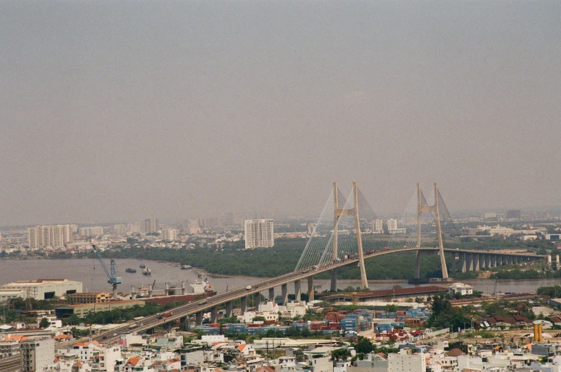 the large bridge is across from many buildings