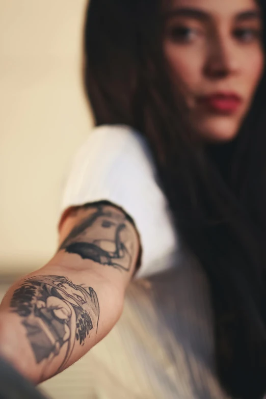 a woman with a tattoo on her arm