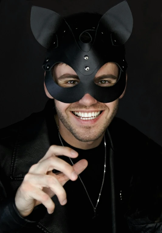a man wearing a black mask and smiling