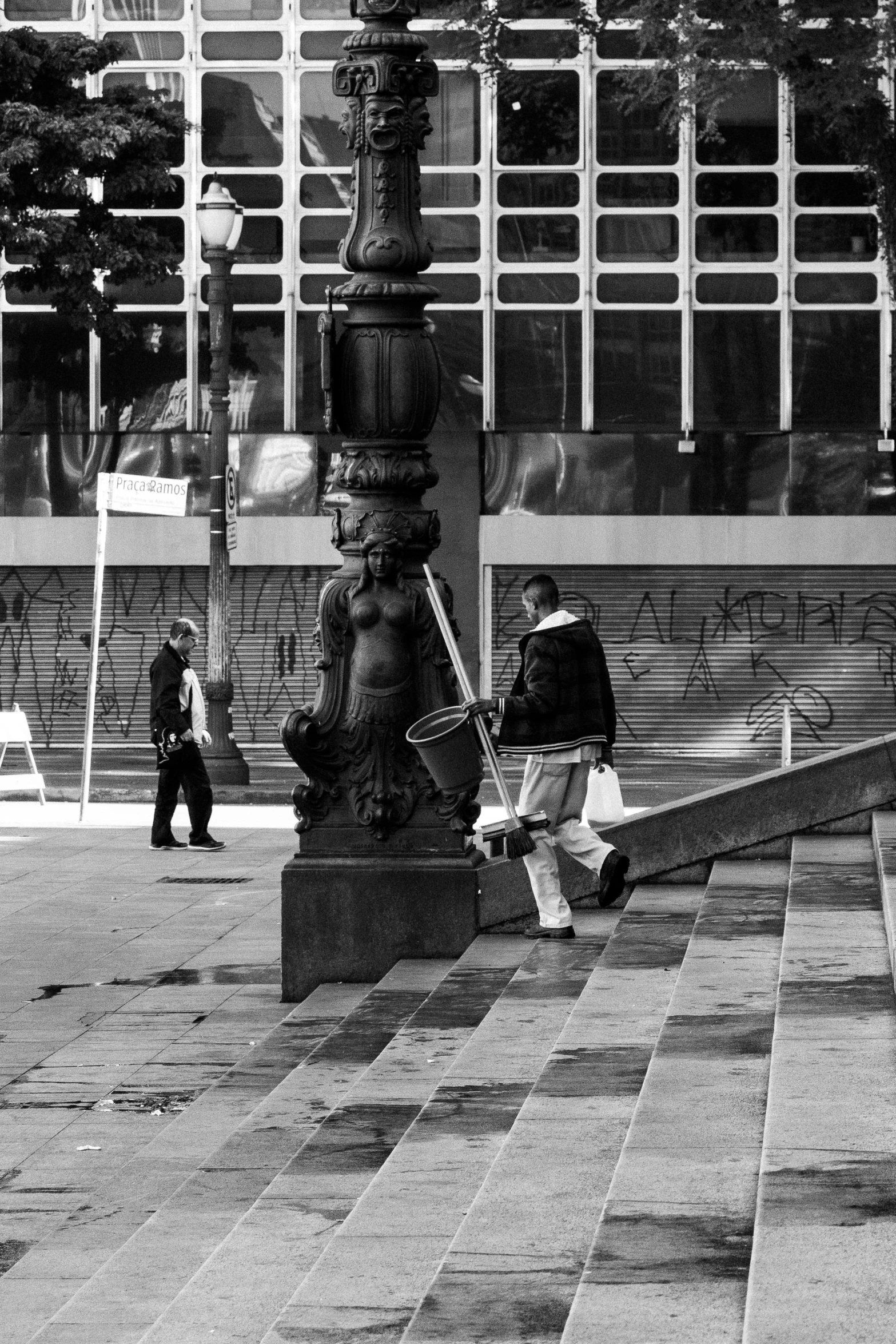 a man sitting on a bench in a public square