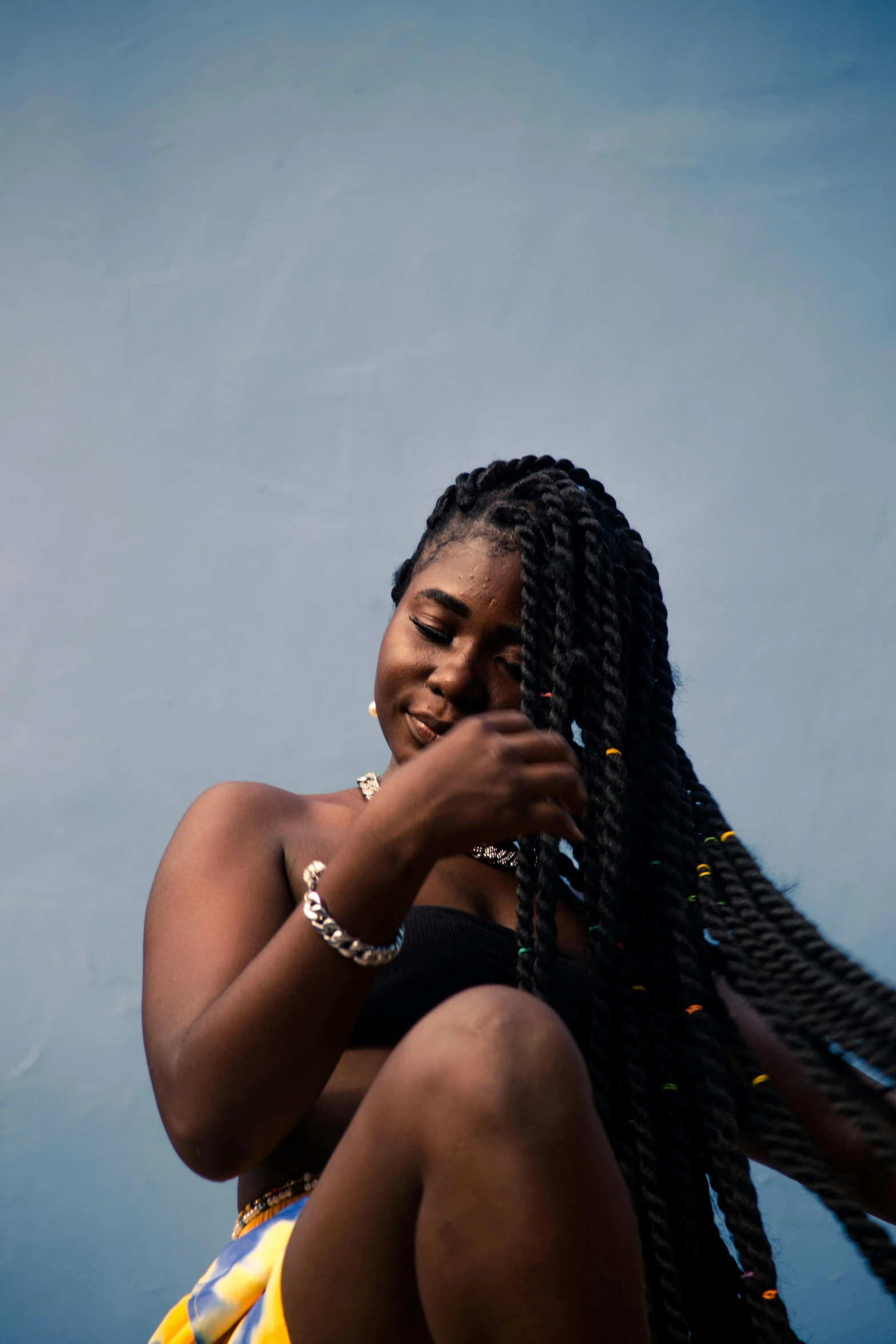 a person holding up two different hair styles