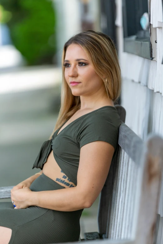 a women who is posing next to some siding