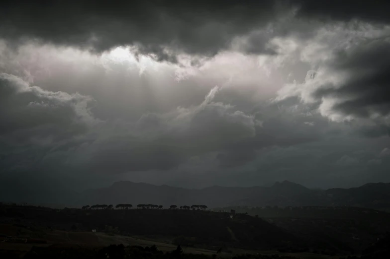 the dark clouds are gathering on the mountains