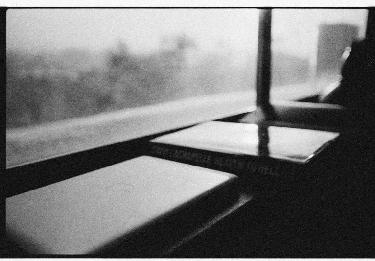 an open window in black and white with someone looking out the window