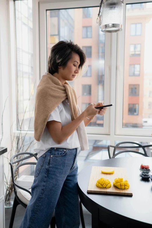 a woman using her cell phone at a table