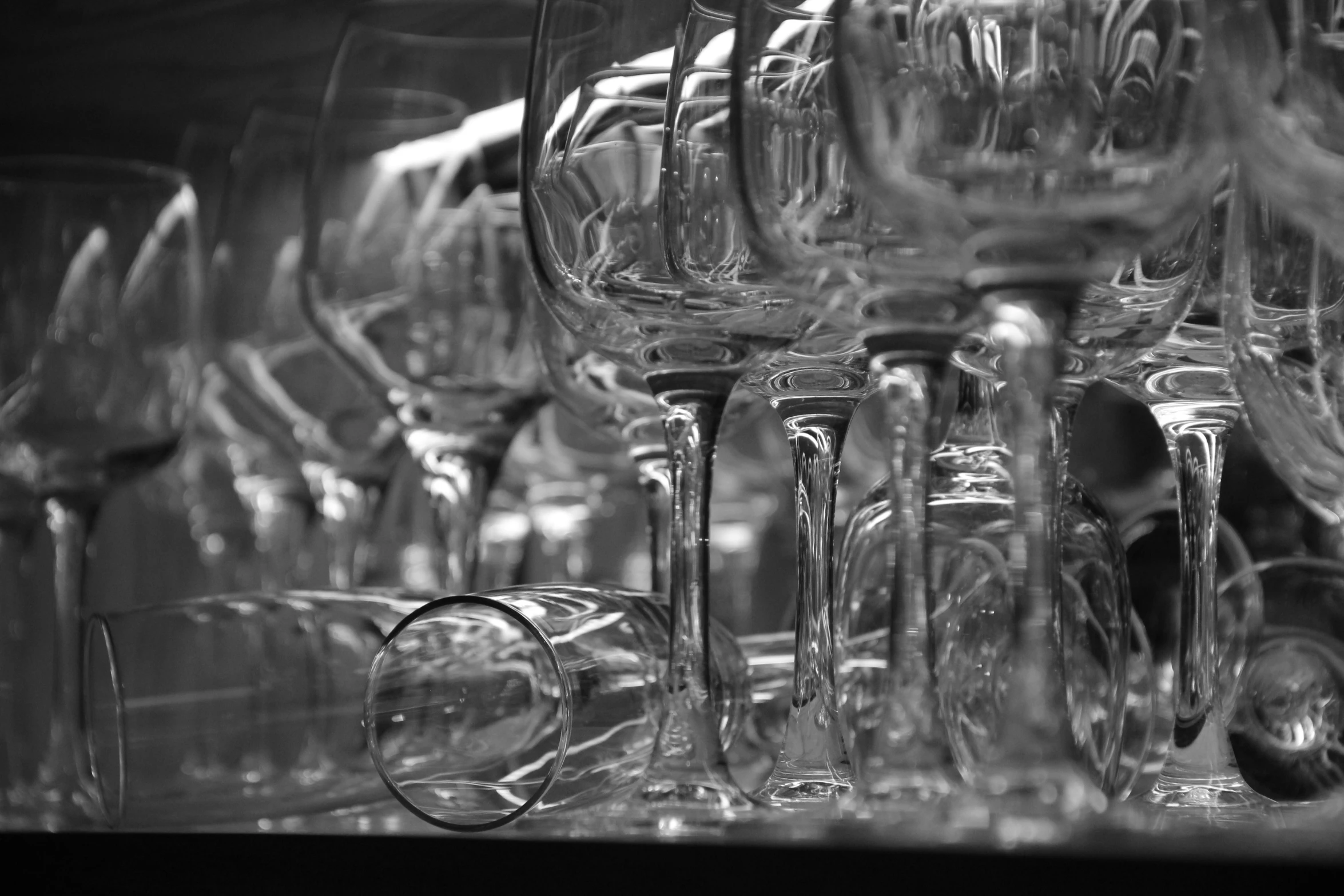 a bunch of wine glasses are stacked up on a table