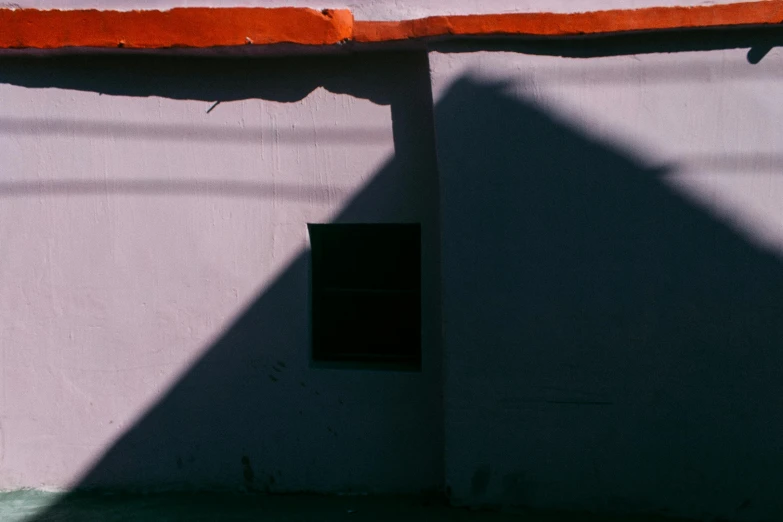 shadow on concrete wall with window and cat