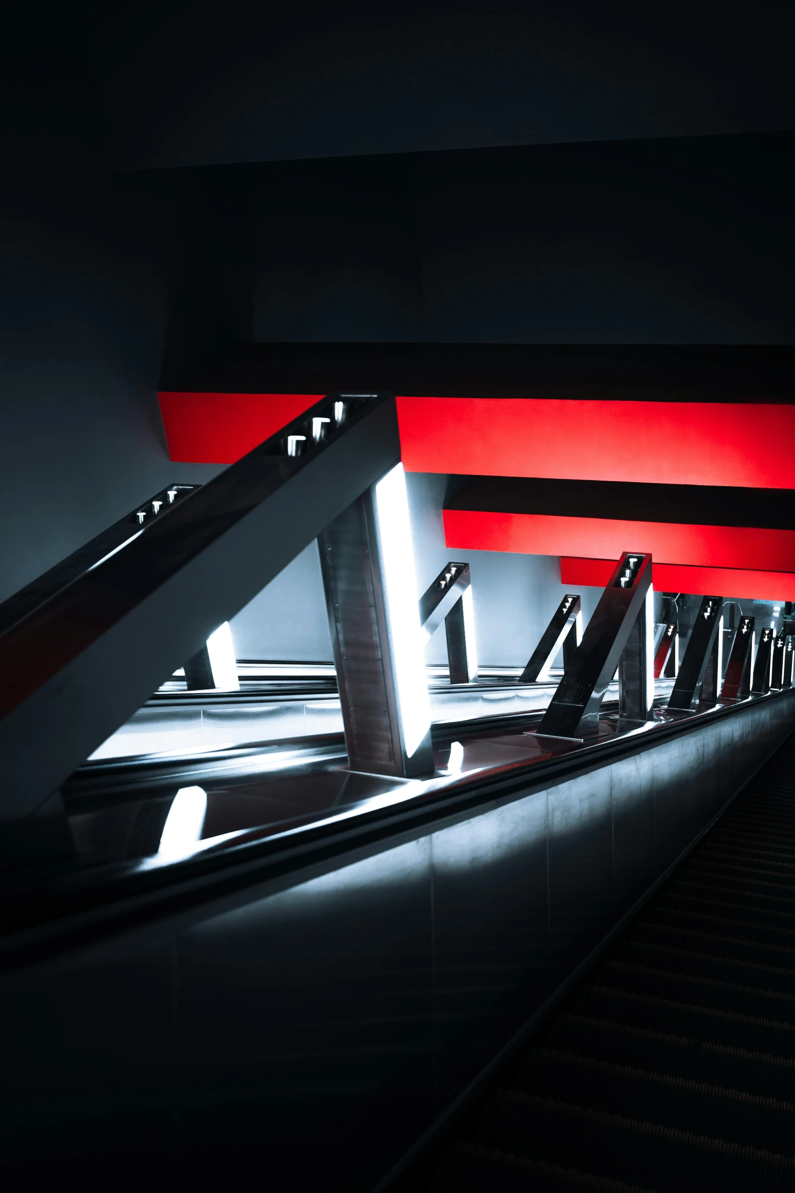 an escalator with a red line going down the side of it