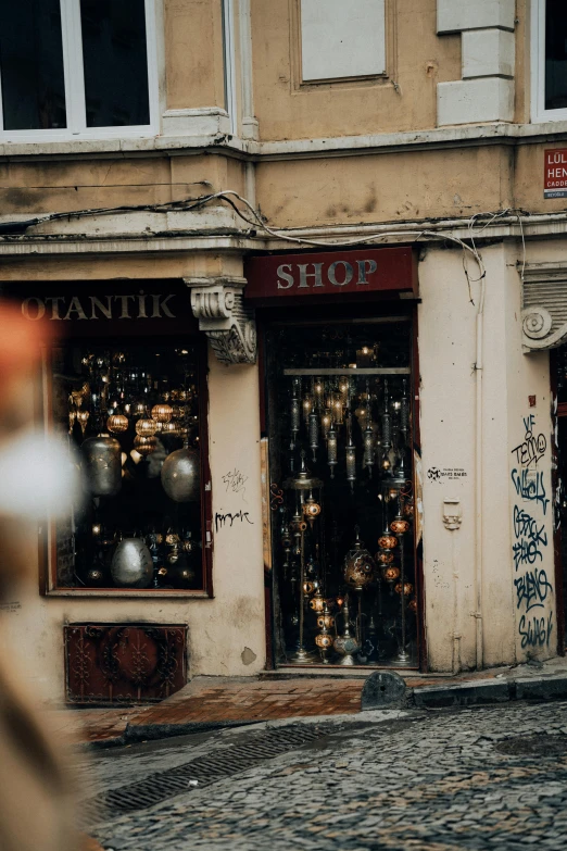 an empty stone pavement in front of a shoe store