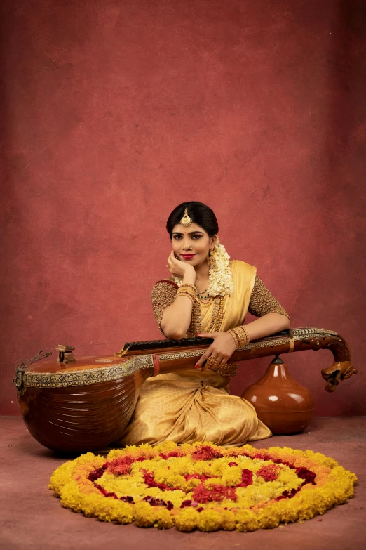 an indian woman sits under a flower design