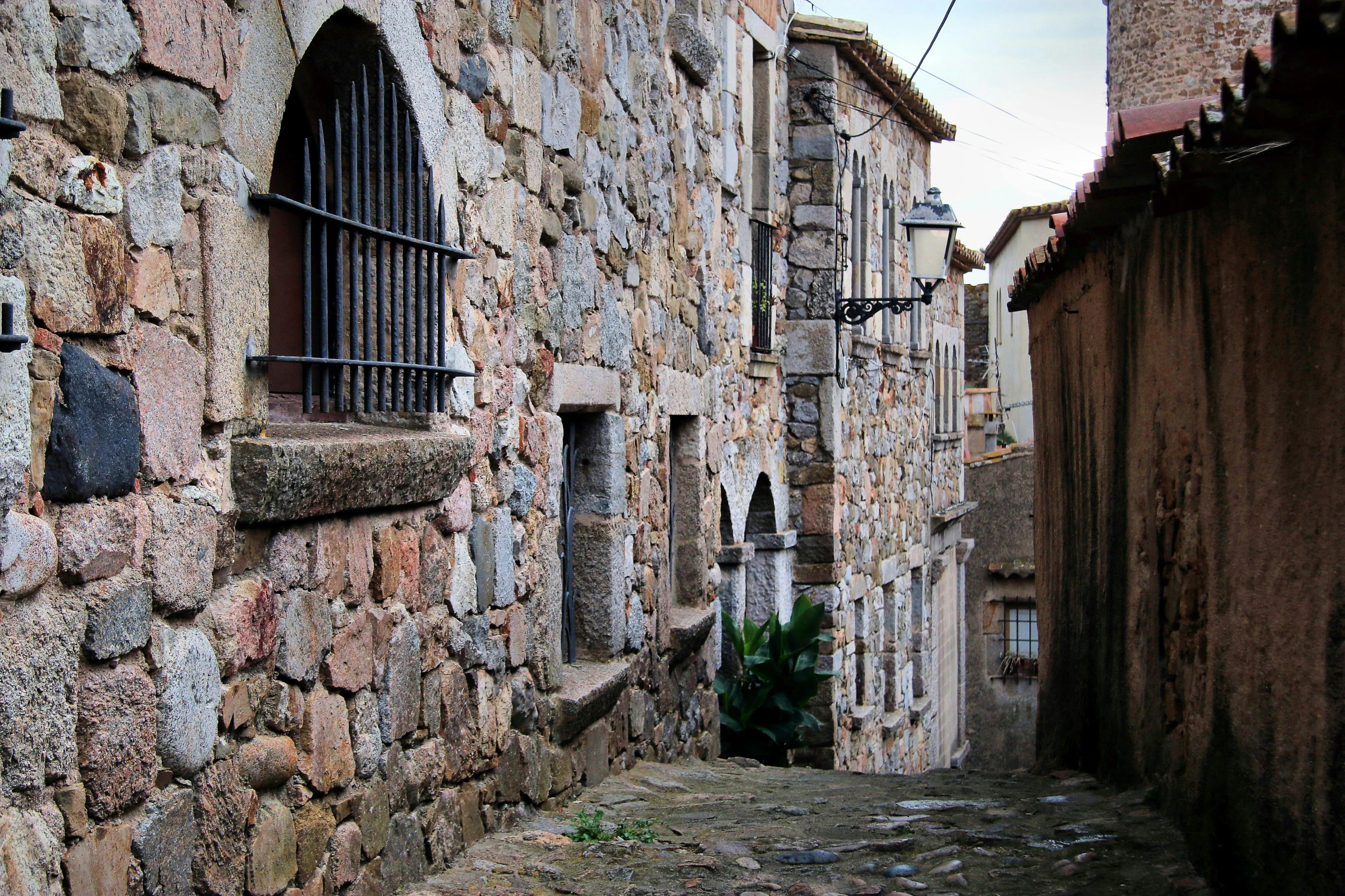 there is a small window in a stone wall