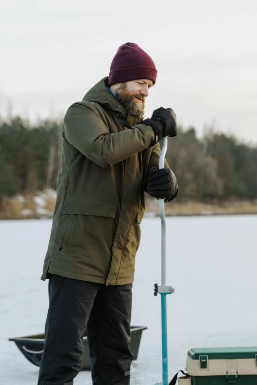 a man standing by some water on his skis