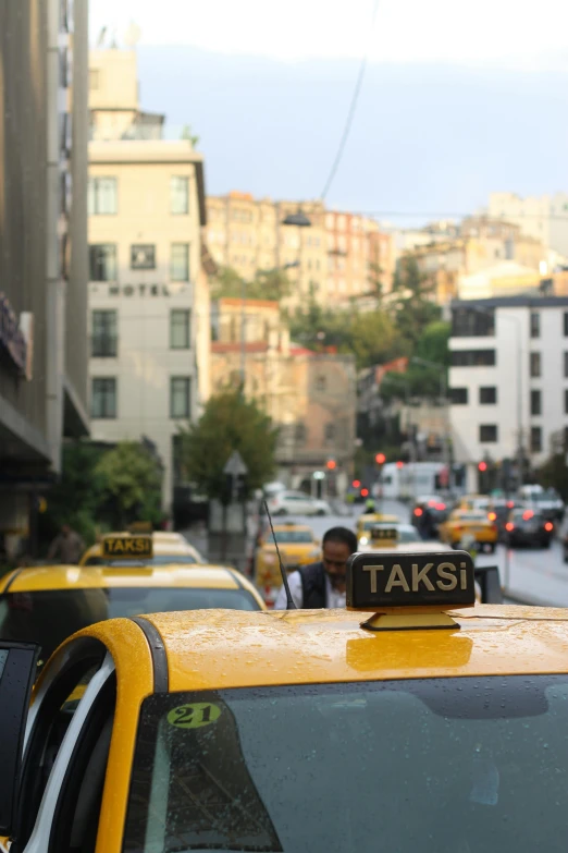 the taxi cab is lined up on a busy street