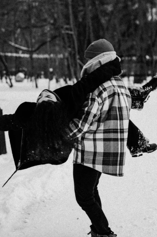 the back of a snowboarder on his board with the camera