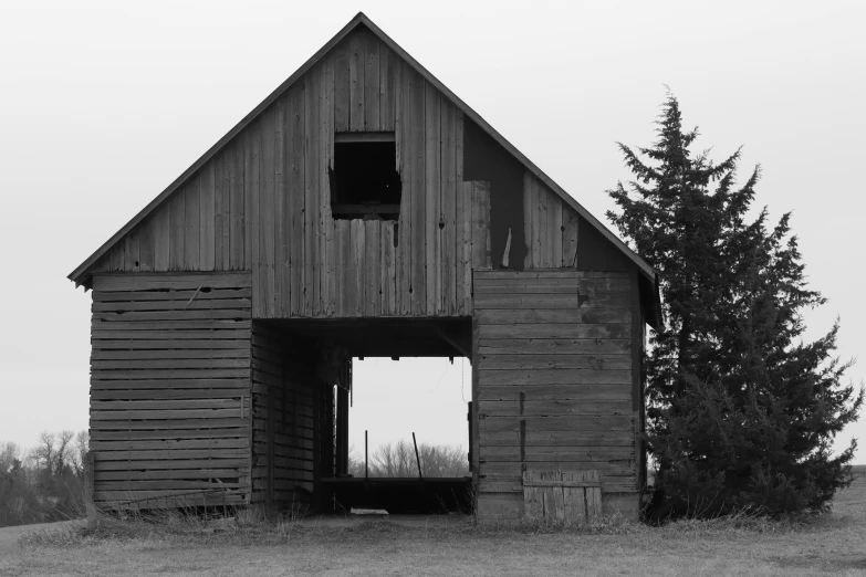 an old barn in black and white with no roof