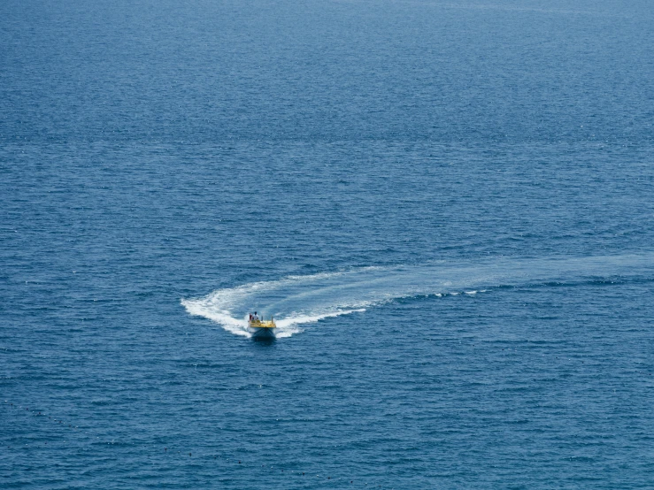 two people in a boat on a large body of water