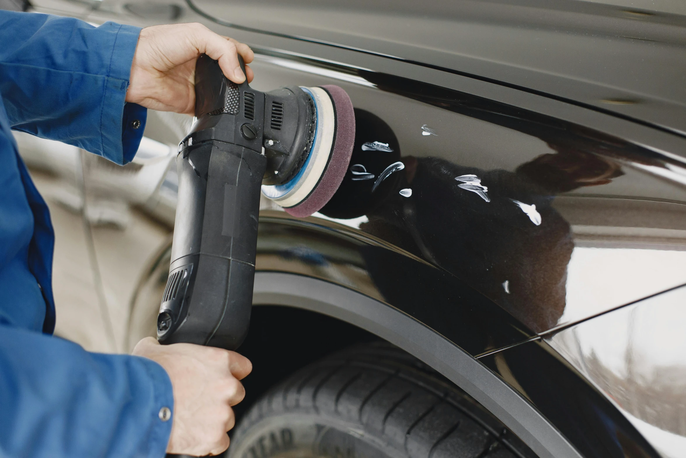 a person is grinding on the side of a car