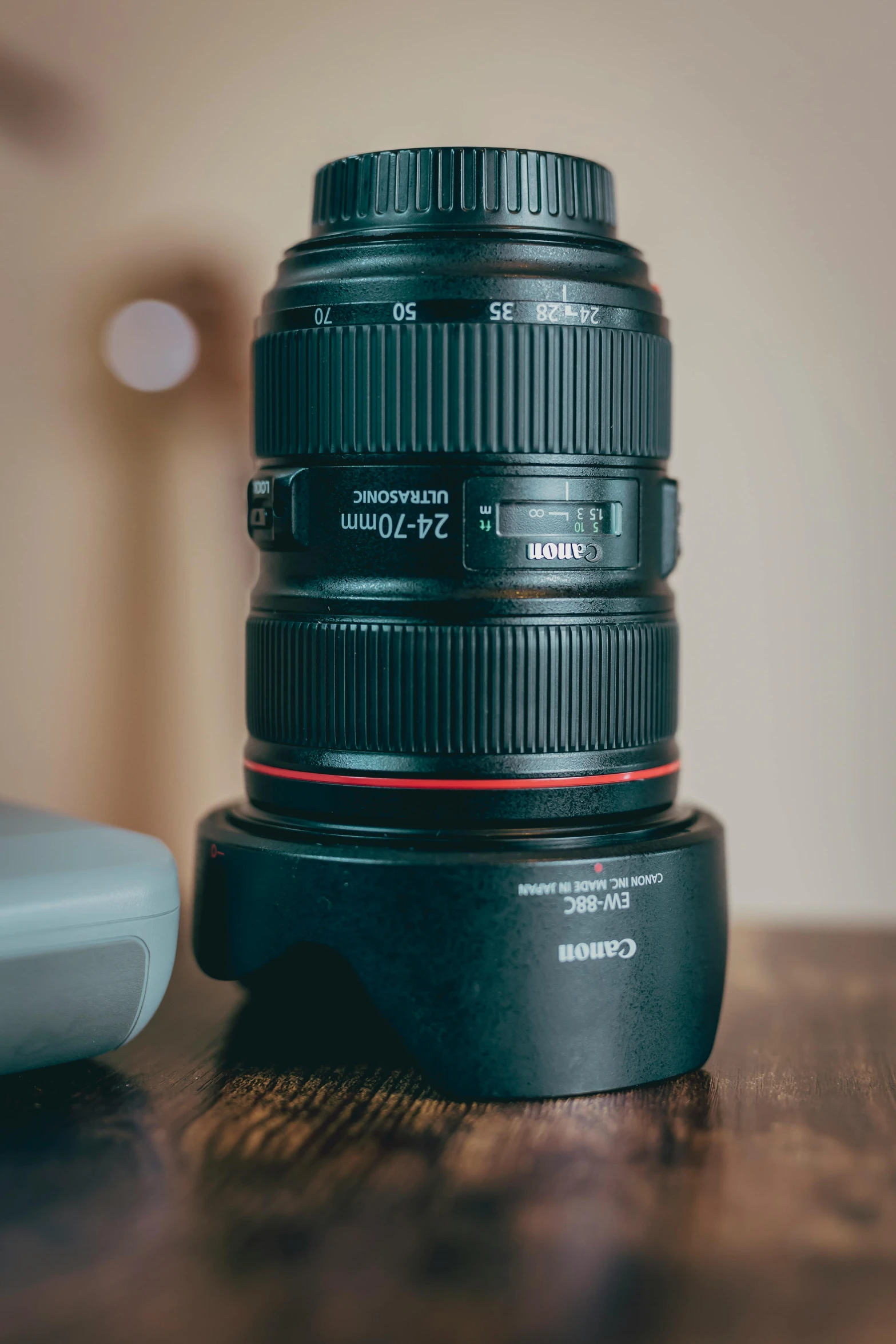 a camera lens on a table next to a device