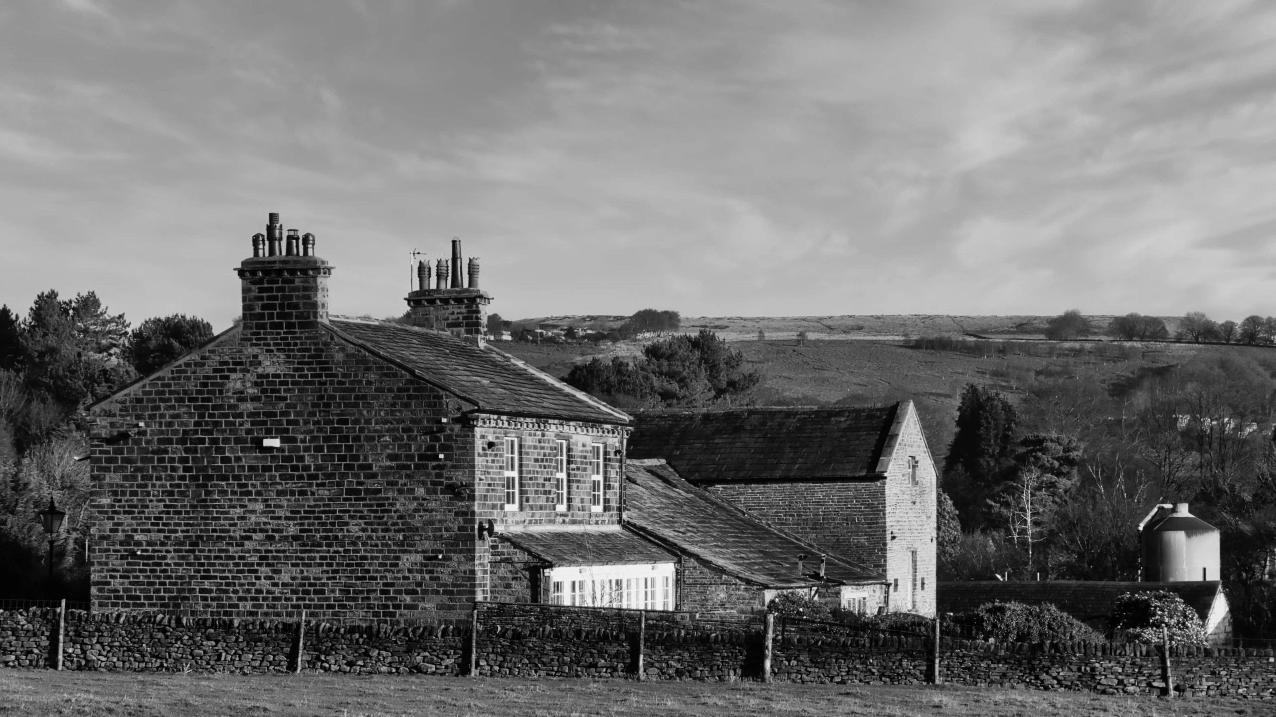 the farm house is surrounded by a fence