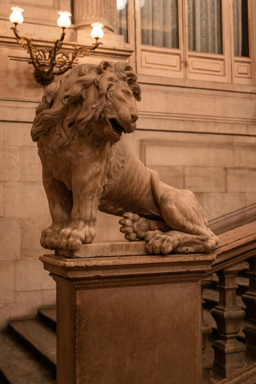 lion statue sitting on a bench next to the stairs