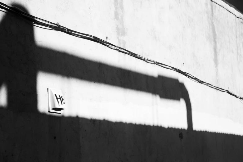 the shadow of a fence, an electronic device and wires