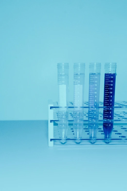 glass tubes sitting on top of a blue background