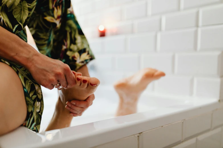 a person has their bare legs in the bathtub