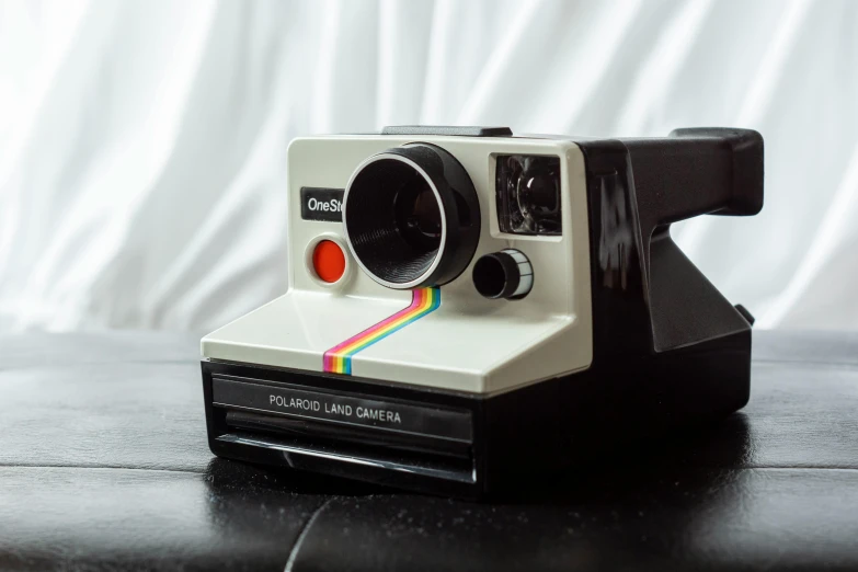 a polaroid camera with an extra lens attached