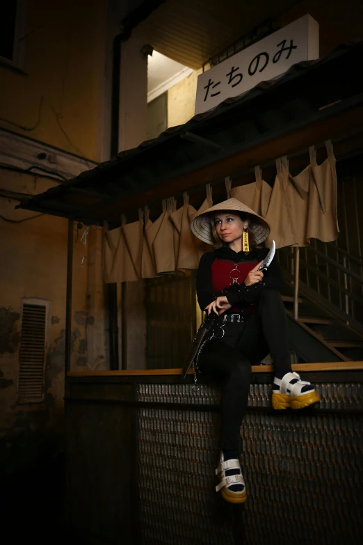 an asian woman is sitting on some stairs