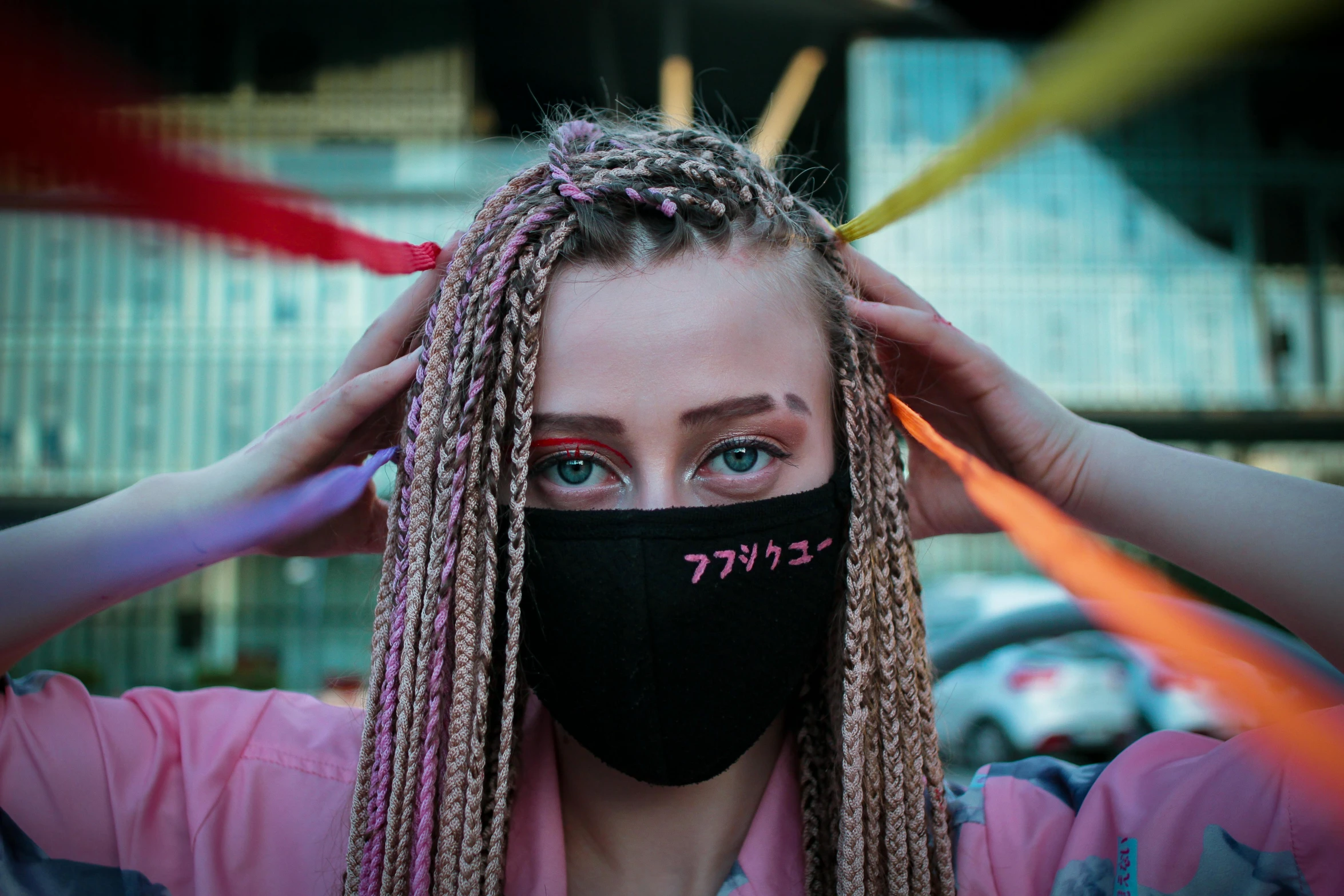 a woman wearing a black mask and dread locks