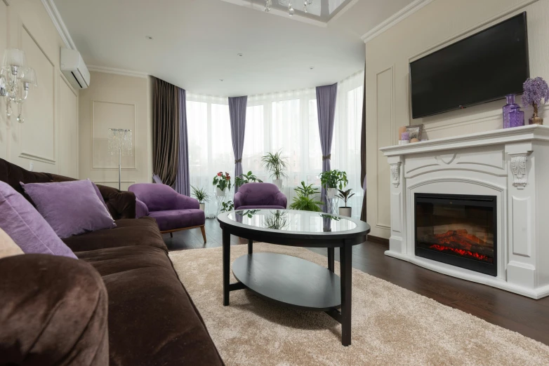 a living room with couches, a coffee table, and a fireplace