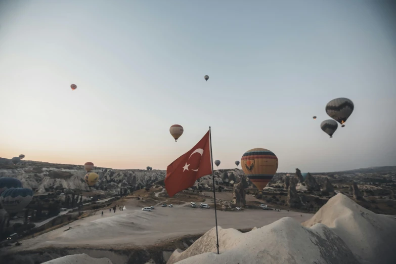 many  air balloons are flying over an island