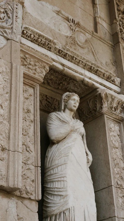 a stone statue is next to an ornate doorway