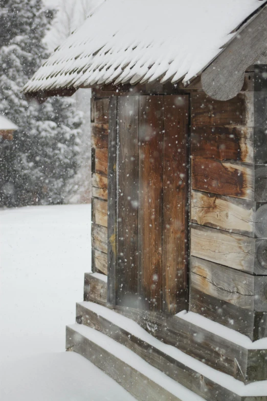 a cabin building is shown covered in snow