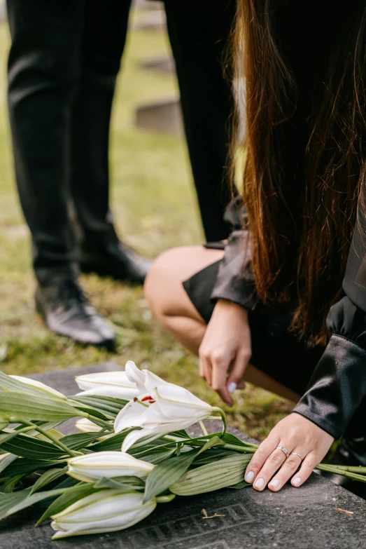 flowers are laid on a grave for a funeral