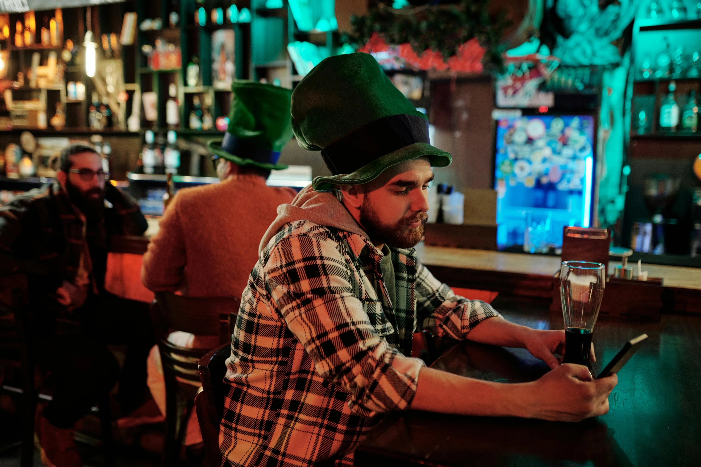 a man wearing a hat and holding a beer