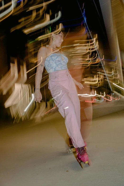 a girl in pink riding a skateboard at night